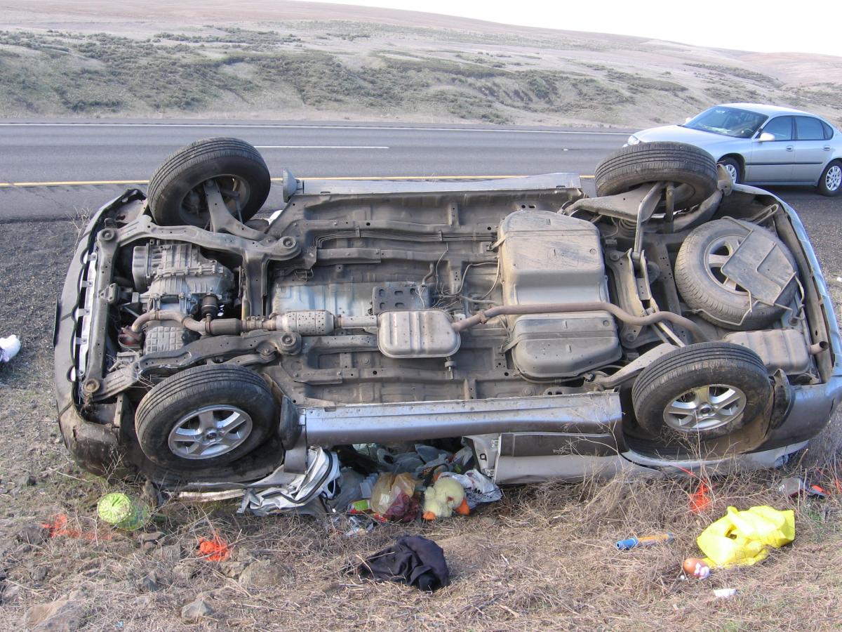 The underside of a car, rolled over on the side of the road
